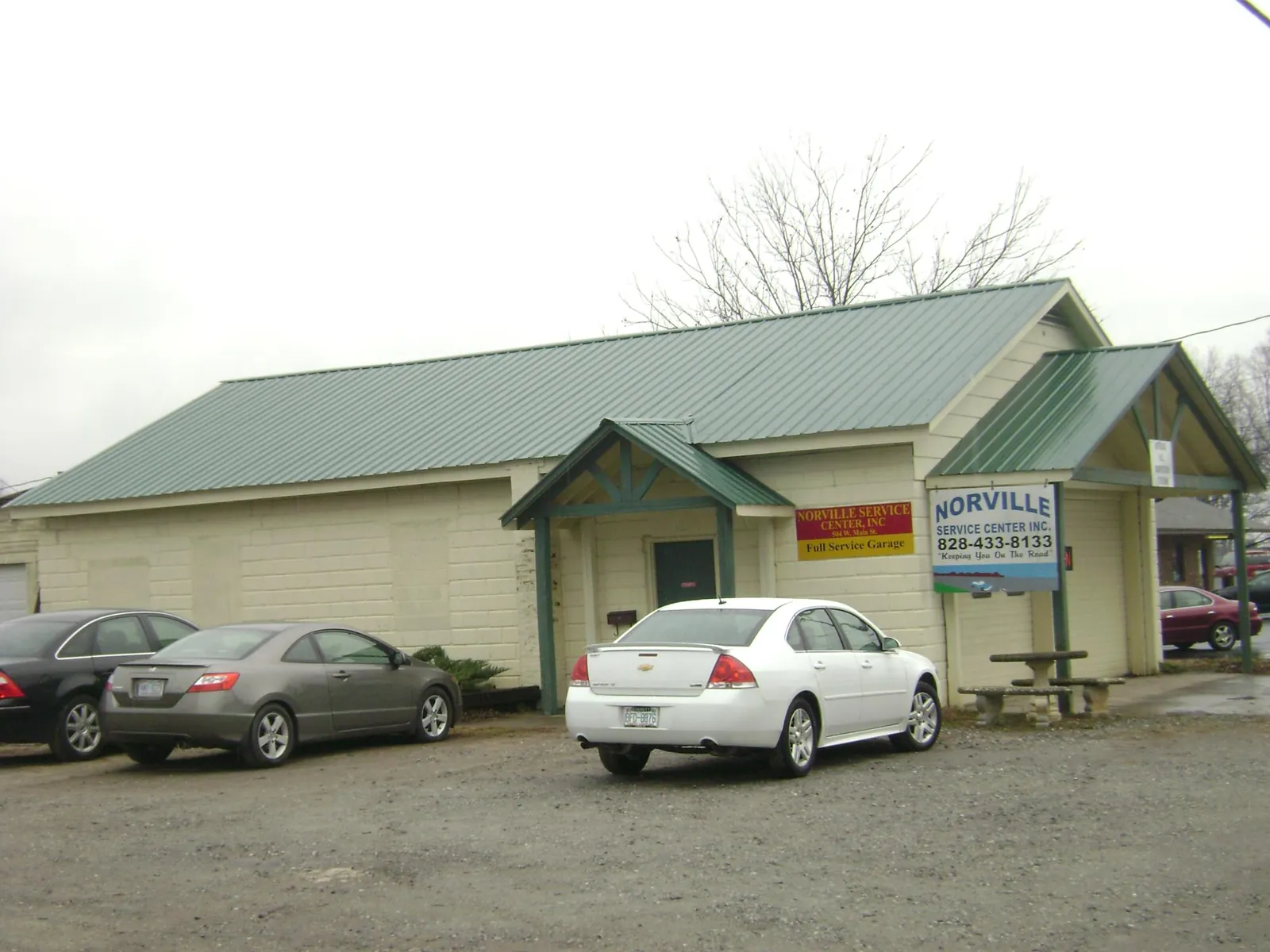 Green metal roof on a service garage with a covered entry in Samaria